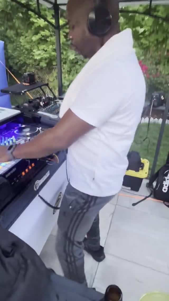 Mixing music at an outdoor event. Silent preview.